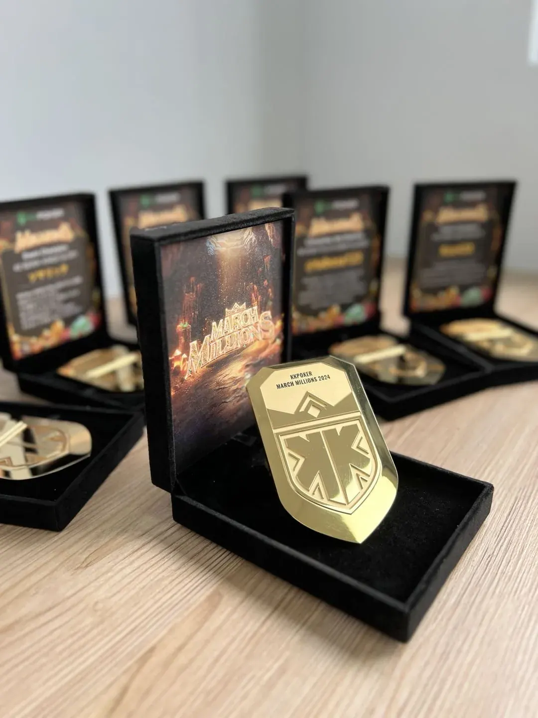 Engraved gold medals in velvet boxes on a table